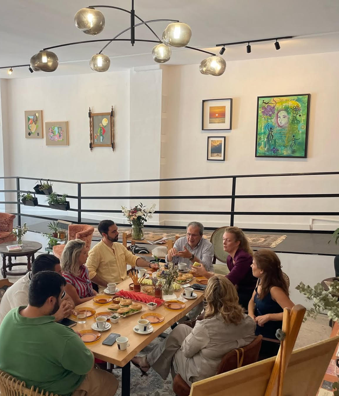 Corporate gathering around a long table at ŪLFA Studios